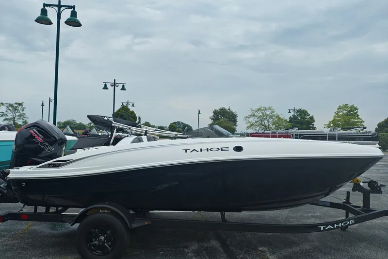 Slide: The Image of 2027 Tahoe T18 boat on trailer, parked outdoors under cloudy sky. - 3
