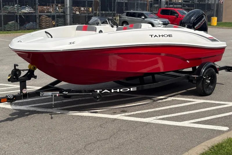 Slide: The Image of 2027 Tahoe T16 boat in red and white on a trailer in a parking lot. - 2
