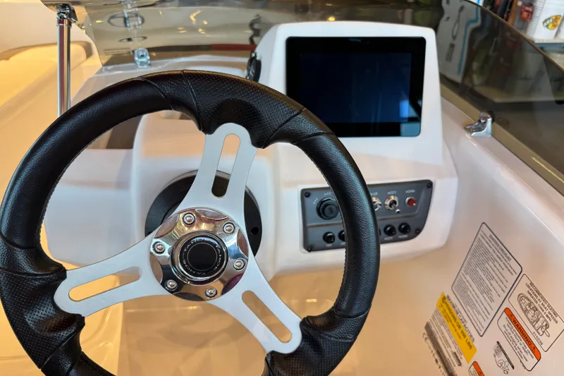 Slide: The Image of Steering wheel and dashboard of 2027 Tahoe T16 boat with touchscreen display. - 64