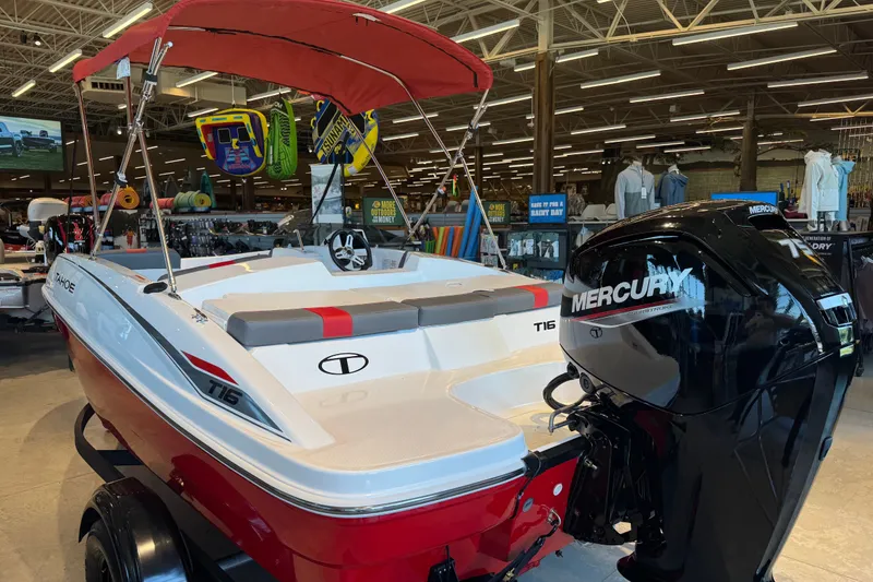 Slide: The Image of 2027 Tahoe T16 boat with Mercury engine displayed indoors, featuring red and white design. - 60