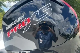 Slide: The Image of Mercury Pro XS engine on a 2027 Tahoe T18 boat, reflecting sky and person. - 4