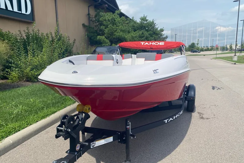 Slide: The Image of 2027 Tahoe T16 boat on trailer, red and white design, parked outdoors. - 1