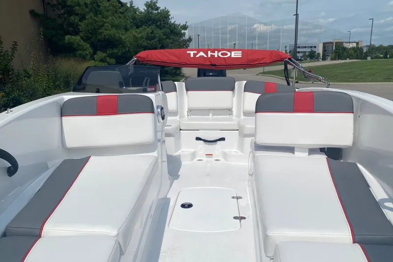 Slide: The Image of 2027 Tahoe T16 boat interior with white and gray seating, red accents, and canopy. - 4