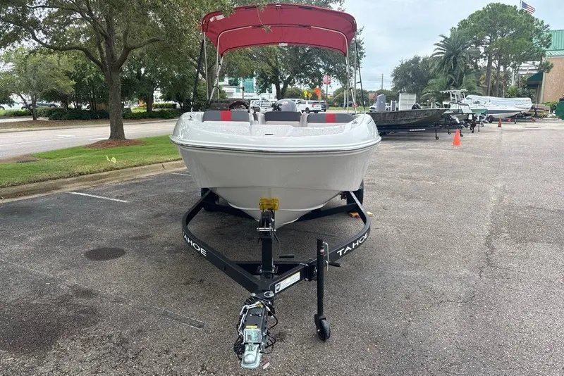 Slide: The Image of 2027 Tahoe T18 boat with red canopy on trailer in parking lot. - 7