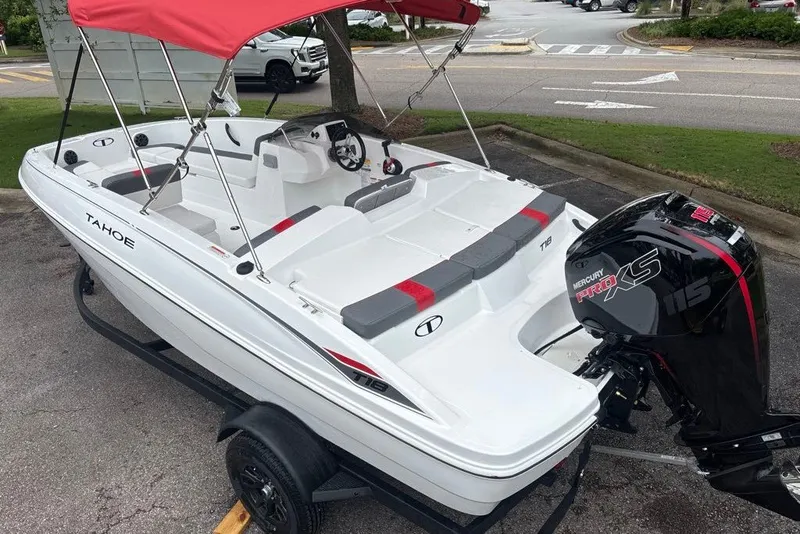 Slide: The Image of 2027 Tahoe T18 boat with red canopy and Mercury Pro XS 115 engine on trailer. - 2