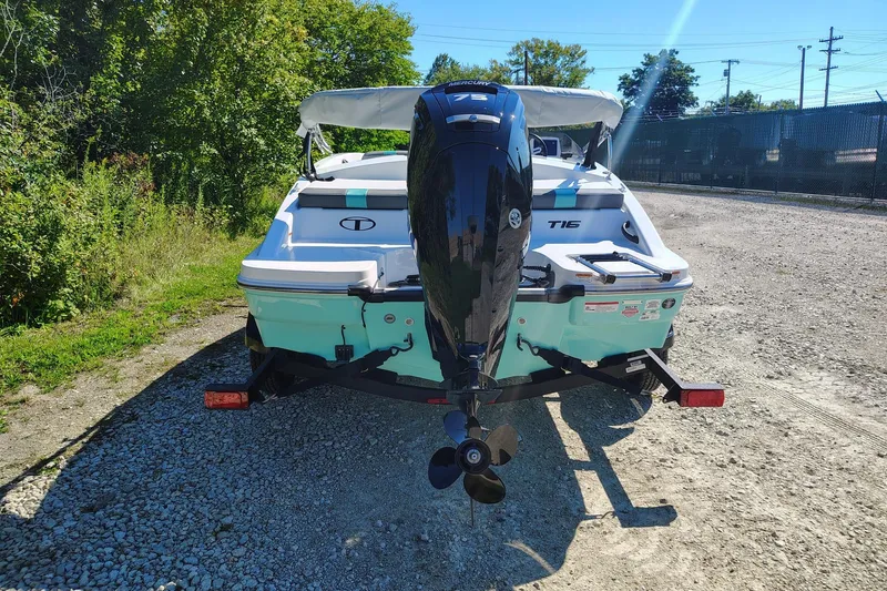 Slide: The Image of 2027 Tahoe T16 boat with outboard motor on a gravel path. - 2