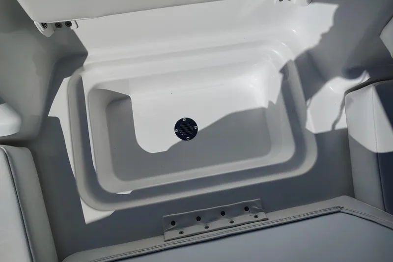 Slide: The Image of 2027 Tahoe T16 boat interior storage compartment, white finish, with seating area. - 6