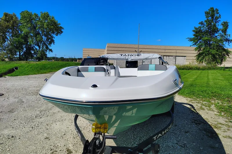 Slide: The Image of 2027 Tahoe T16 boat on trailer, parked outdoors under clear blue sky. - 1