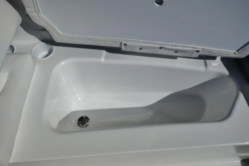 Slide: The Image of 2027 Tahoe T16 boat storage compartment with open lid, showcasing sleek white interior design. - 4