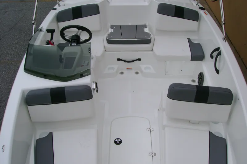 Slide: The Image of 2027 Tahoe T16 boat interior with seating, steering wheel, and storage compartments. - 9