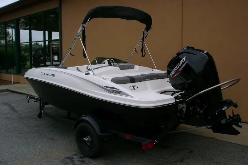 Slide: The Image of 2027 Tahoe T16 boat with Mercury engine, parked outdoors on a trailer. - 5