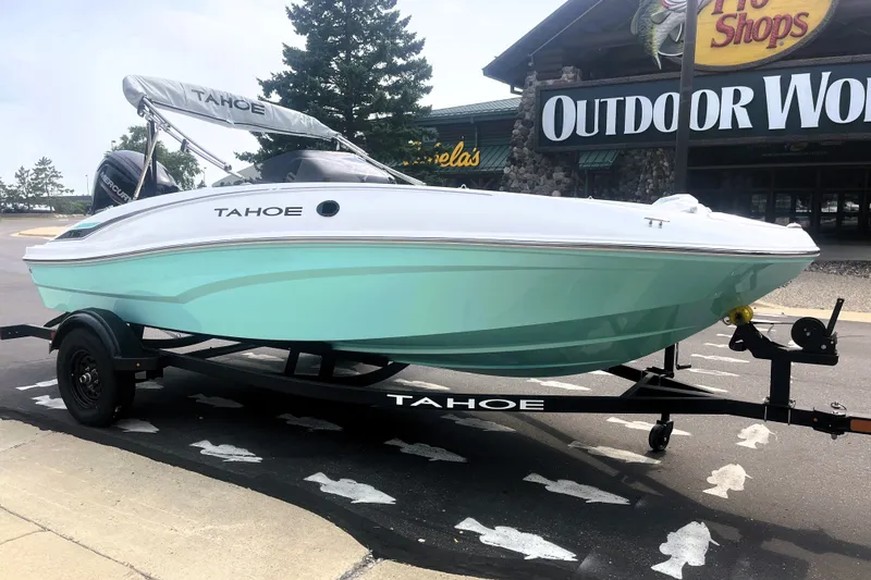 Slide: The Image of 2027 Tahoe T16 boat on trailer outside Outdoor World store. - 1