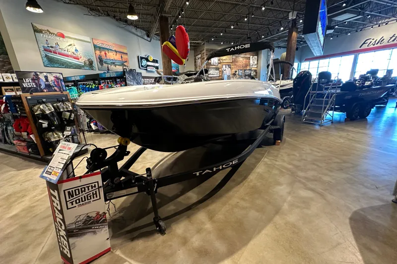Slide: The Image of 2027 Tahoe T18 boat displayed in a showroom with boating accessories. - 2