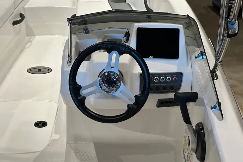 Slide: The Image of 2027 Tahoe T18 boat dashboard with steering wheel and control panel. - 6