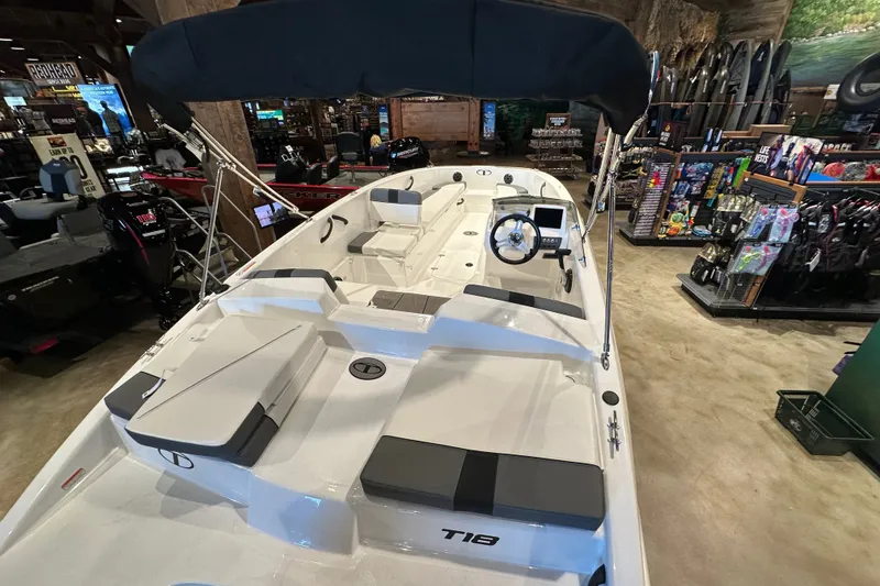 Slide: The Image of 2027 Tahoe T18 boat displayed in a showroom with accessories and equipment. - 5