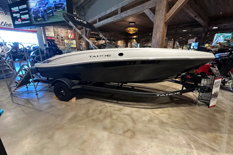 Slide: The Image of 2027 Tahoe T18 boat displayed indoors on a trailer, showcasing sleek design and modern features. - 1