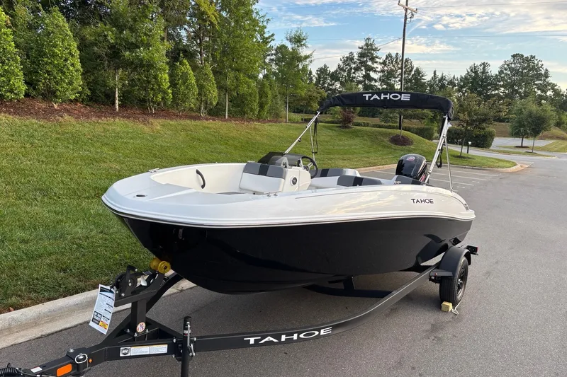 Slide: The Image of 2027 Tahoe T18 boat on trailer in a parking lot, surrounded by greenery. - 3