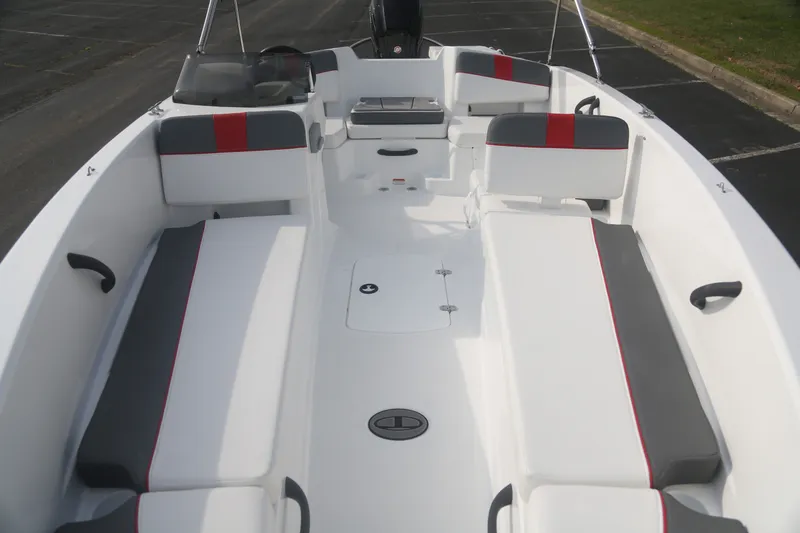 Slide: The Image of 2027 Tahoe T18 boat interior with white and gray seating, red accents, and spacious layout. - 2