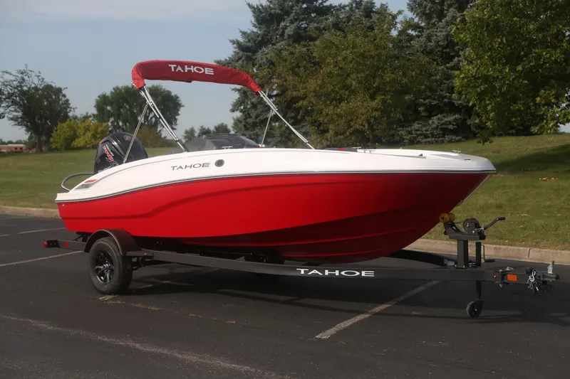Slide: The Image of 2027 Tahoe T18 boat in vibrant red on a trailer, parked outdoors. - 1
