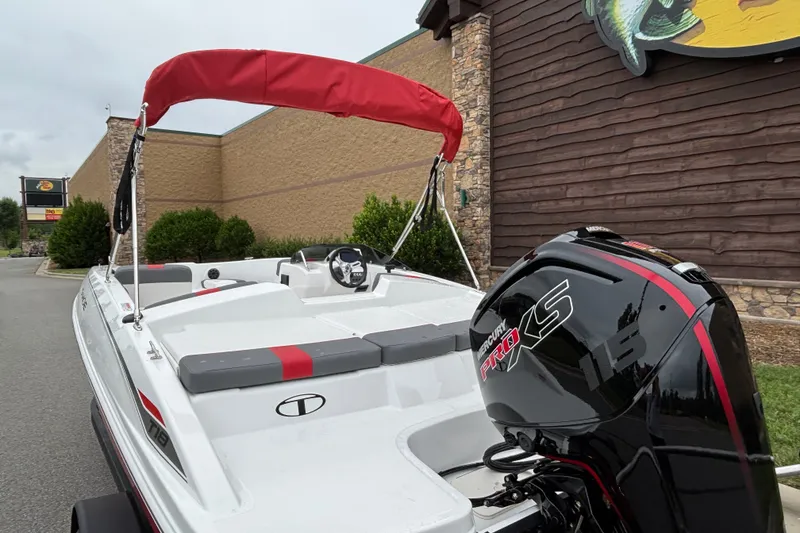 Slide: The Image of 2027 Tahoe T18 boat with red canopy and Mercury Pro XS engine. - 70