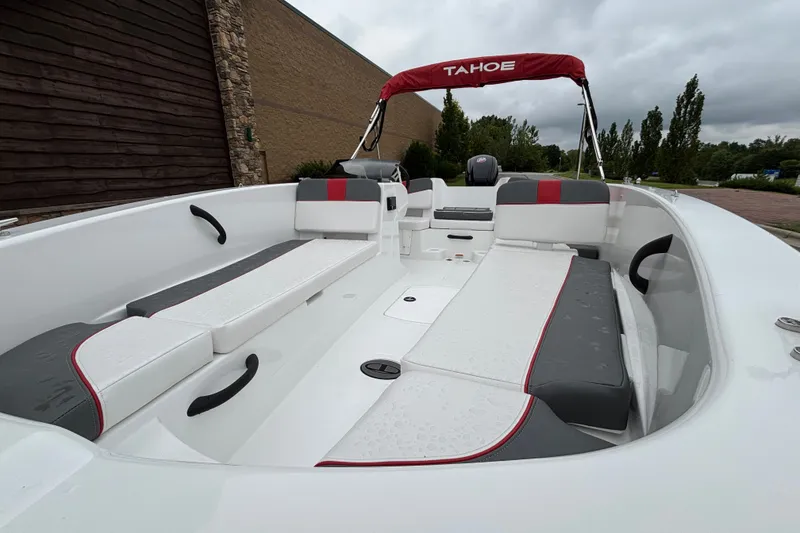 Slide: The Image of 2027 Tahoe T18 boat interior with sleek seating and modern design under a cloudy sky. - 67