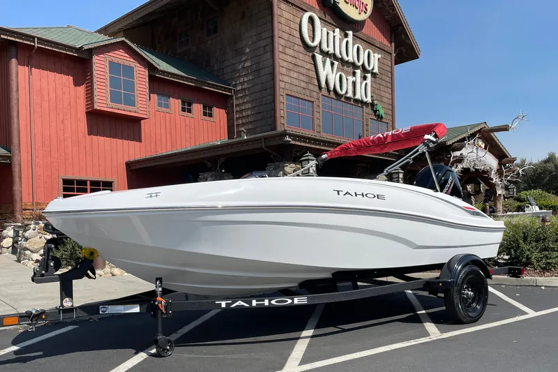 Slide: The Image of 2027 Tahoe T16 boat on trailer outside Outdoor World store. - 2