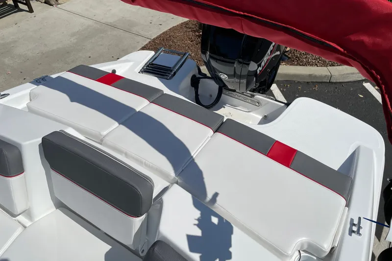 Slide: The Image of 2027 Tahoe T16 boat interior with cushioned seating and outboard motor. - 22