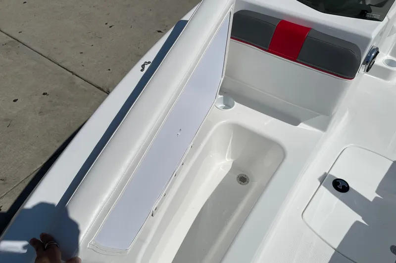 Slide: The Image of 2027 Tahoe T16 boat interior with white and red seating, storage compartment. - 14