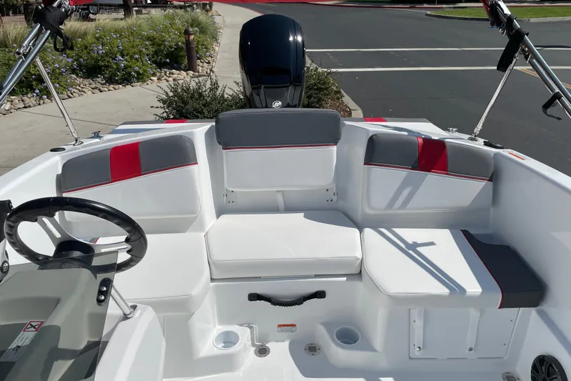 Slide: The Image of 2027 Tahoe T16 boat interior with white and gray seating, red accents, and steering wheel. - 7