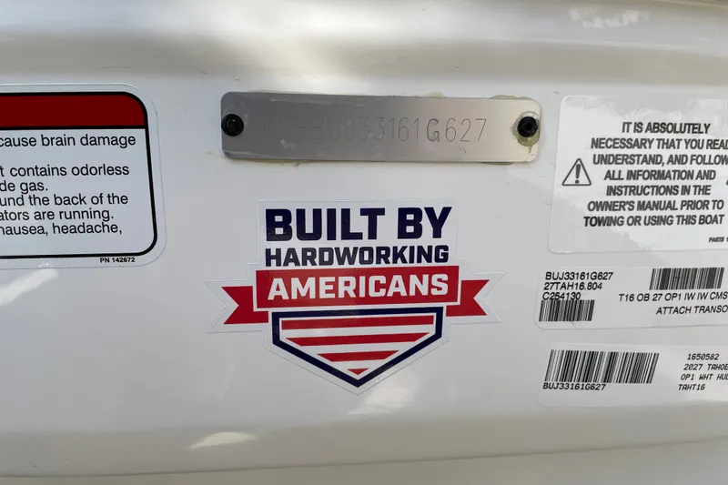 Slide: The Image of 2027 Tahoe T16 boat with safety labels and 'Built by Hardworking Americans' sticker. - 80