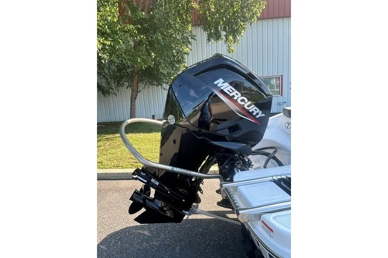 Slide: The Image of 2027 Tahoe T16 boat with Mercury outboard motor, parked outdoors. - 4