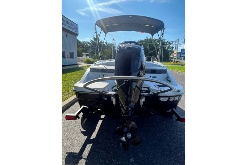Slide: The Image of 2027 Tahoe T16 boat with outboard motor on trailer, parked outdoors. - 3
