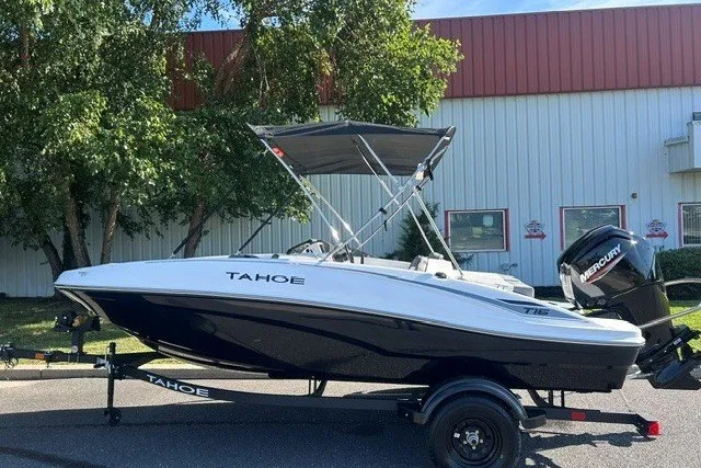Slide: The Image of 2027 Tahoe T16 boat with Mercury engine on trailer, parked outdoors. - 1