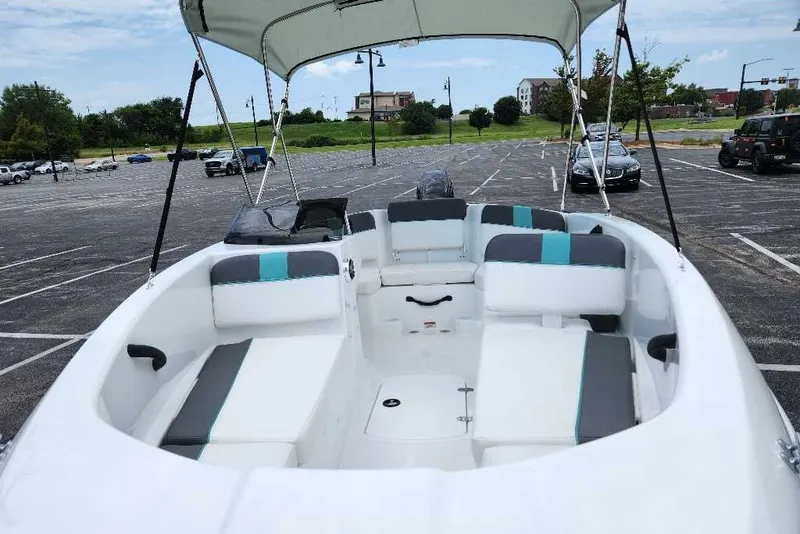 Slide: The Image of 2027 Tahoe T16 boat with canopy in a parking lot, featuring spacious seating. - 13