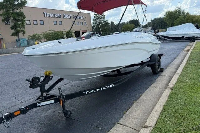 Slide: The Image of 2027 Tahoe T18 boat on trailer at Tracker Boat Center, featuring sleek white design. - 3