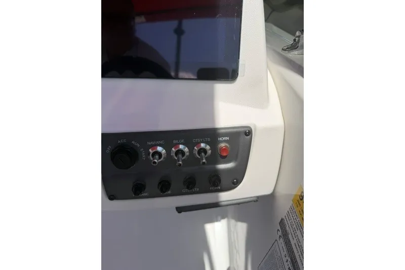 Slide: The Image of Control panel of a 2027 Tahoe T18 boat with switches and buttons. - 15