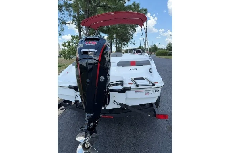 Slide: The Image of 2027 Tahoe T18 boat with Mercury 115 outboard motor, parked on a trailer. - 4