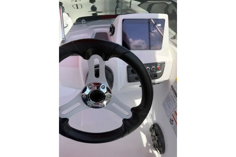 Slide: The Image of Steering wheel and dashboard of 2027 Tahoe T18 boat, featuring modern controls and touchscreen display. - 14
