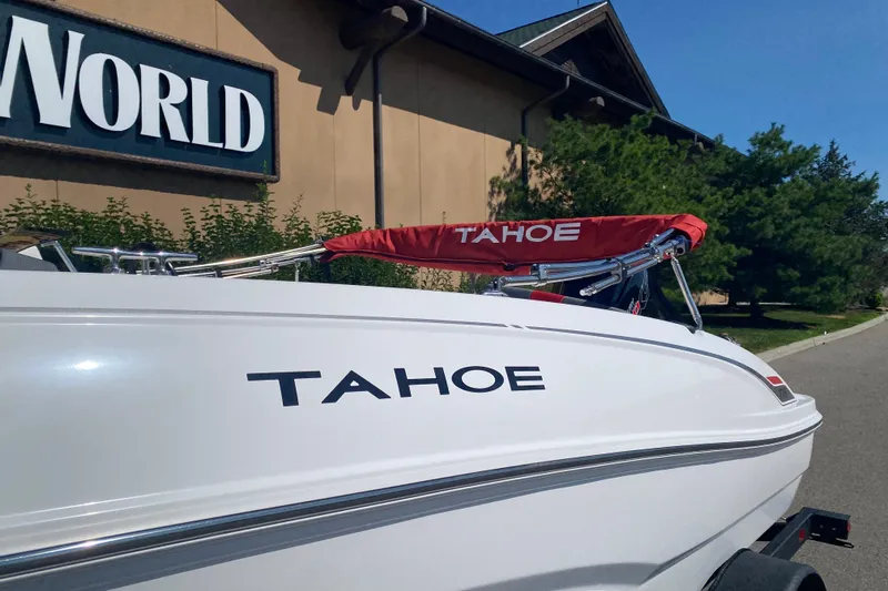 Slide: The Image of 2027 Tahoe T18 boat displayed outdoors near a building with "World" sign. - 1