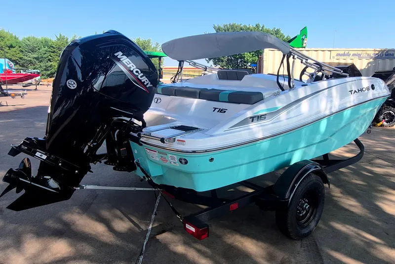 Slide: The Image of 2027 Tahoe T16 boat with Mercury engine on trailer, parked outdoors. - 5