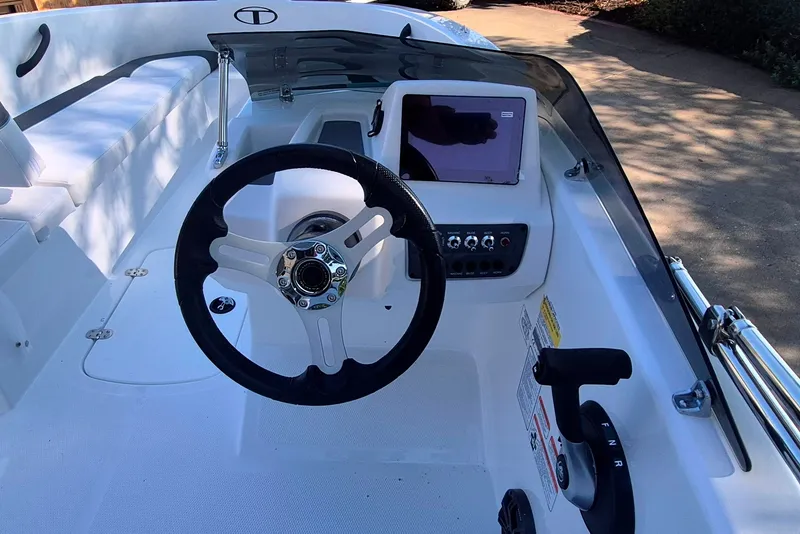 Slide: The Image of Interior of a 2027 Tahoe T16 boat featuring steering wheel and control panel. - 9