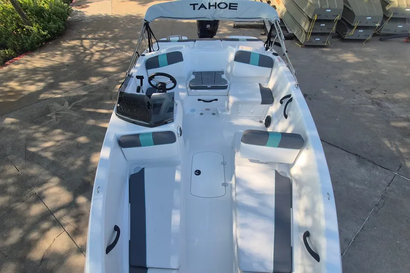 Slide: The Image of 2027 Tahoe T16 boat with white interior and seating, docked outdoors. - 10