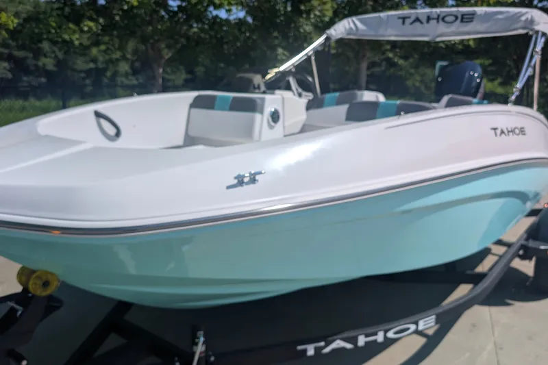 The Image of 2027 Tahoe T16 boat with sleek design on a trailer, outdoors. - 0