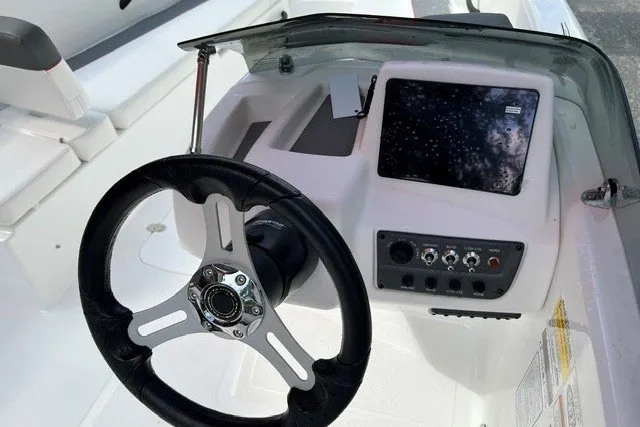 Slide: The Image of 2027 Tahoe T18 boat dashboard with steering wheel and control panel. - 12