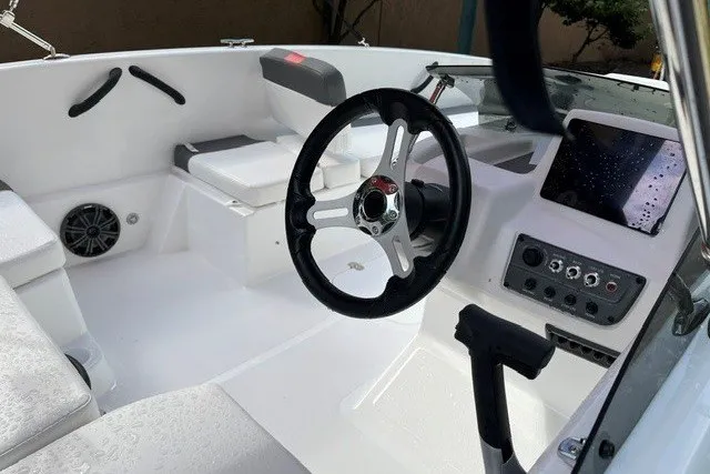 Slide: The Image of Interior of a 2027 Tahoe T18 boat featuring steering wheel and control panel. - 11