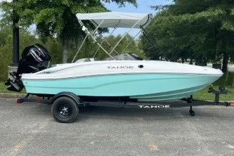 Slide: The Image of 2027 Tahoe T16 boat with canopy on trailer, parked outdoors. - 6
