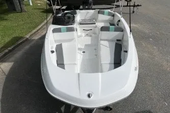 Slide: The Image of 2027 Tahoe T16 boat, white exterior, parked on pavement, top view. - 3