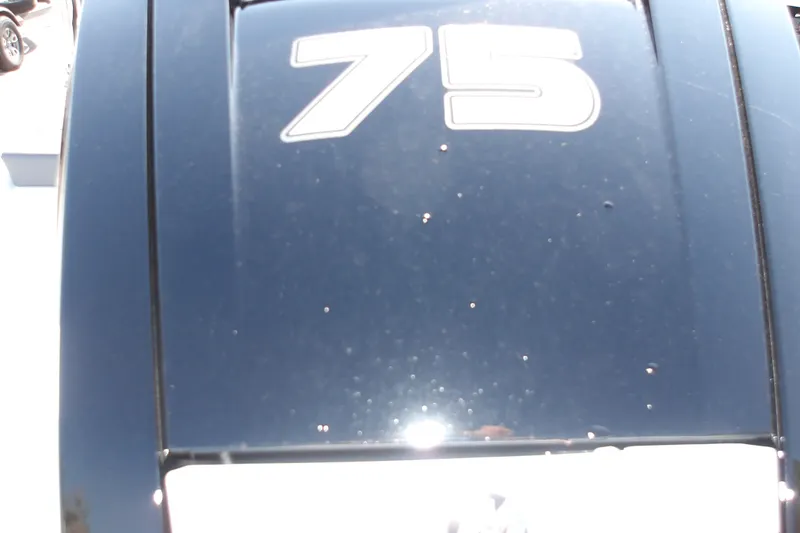 Slide: The Image of Close-up of a 2027 Tahoe T16 boat engine with "75" decal. - 6