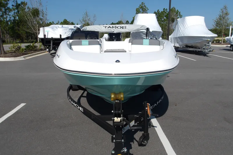 Slide: The Image of 2027 Tahoe T16 boat on trailer in parking lot, surrounded by covered boats. - 3