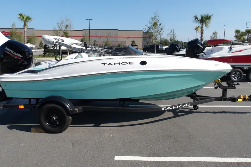 The Image of 2027 Tahoe T16 boat with Mercury engine on trailer in parking lot. - 1